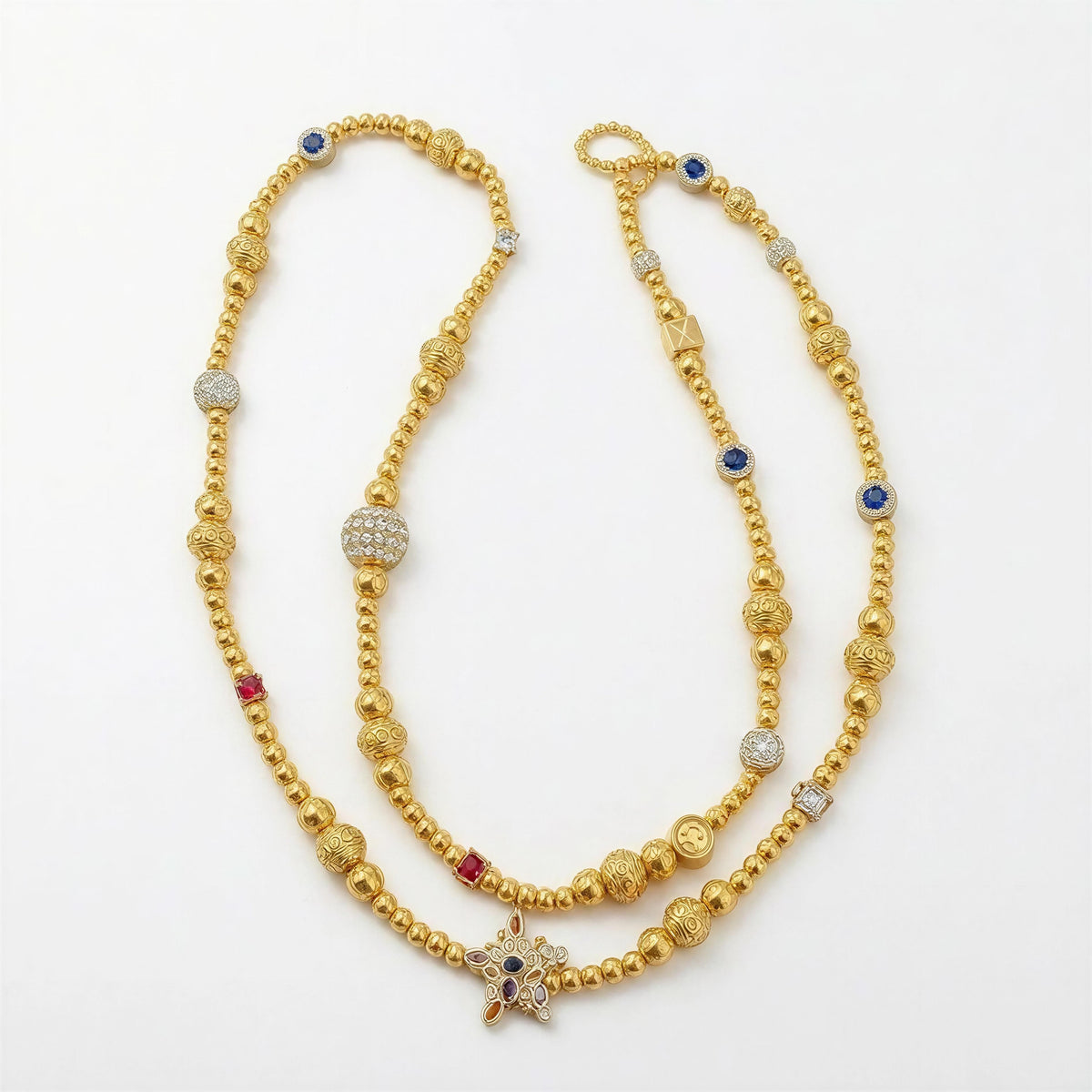 The Rivièra Sunglass Chain - Limited Edition featuring intricate gold beads with accents of blue and red gemstones, sparkling pavé details, and a star-shaped charm, elegantly handcrafted.