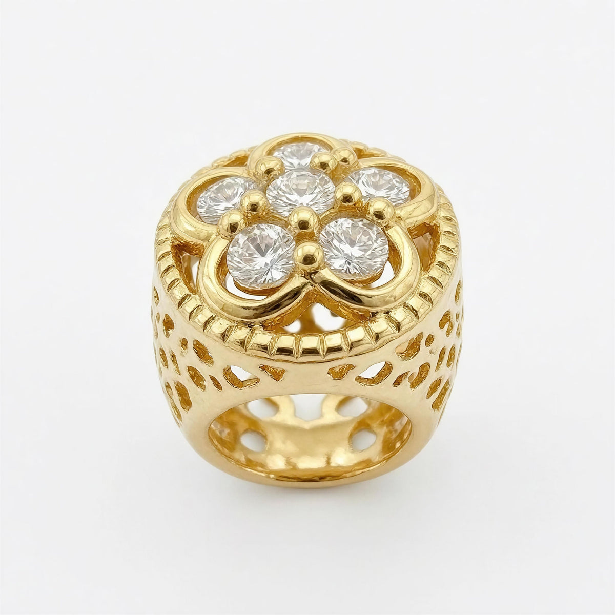 Close-up of an ornate gold charm with intricate openwork and sparkling clear stones, designed as part of The Riviera Sunglass Chain – Rosé Lumière collection.